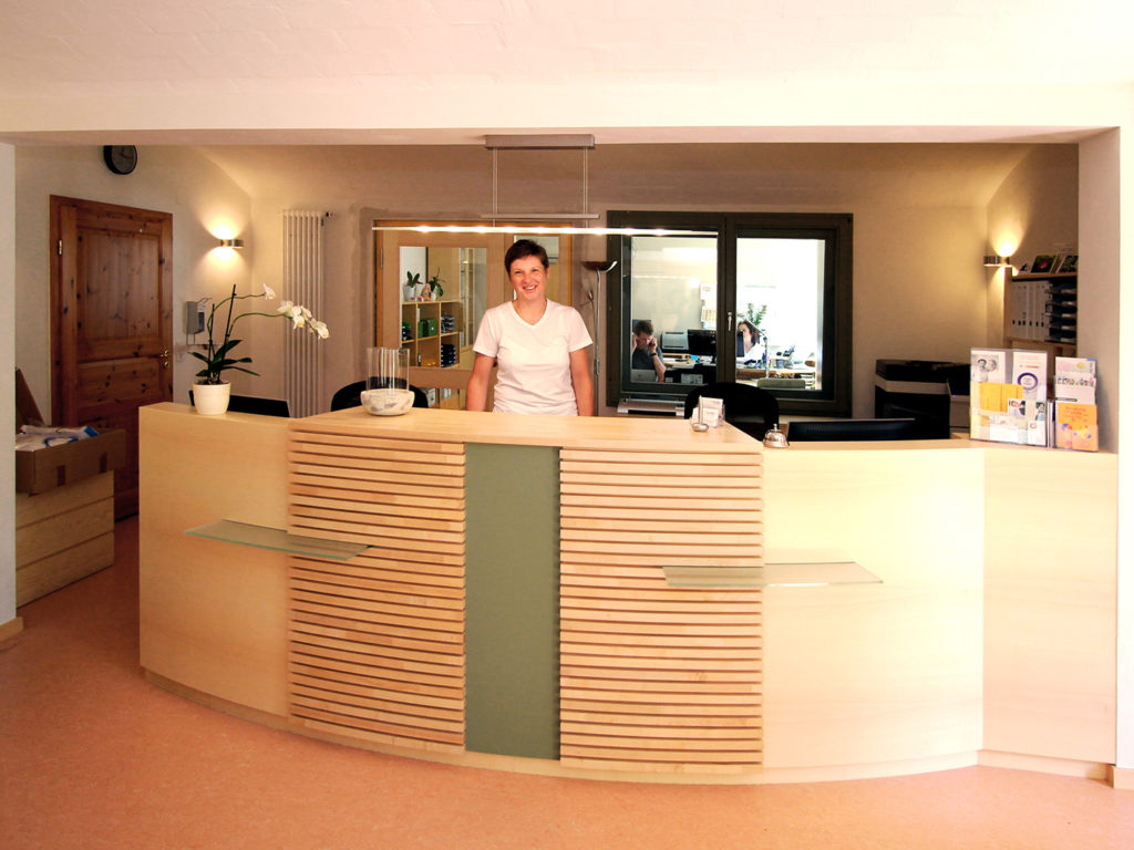 image of a woman standing at arcadia clinic reception desk